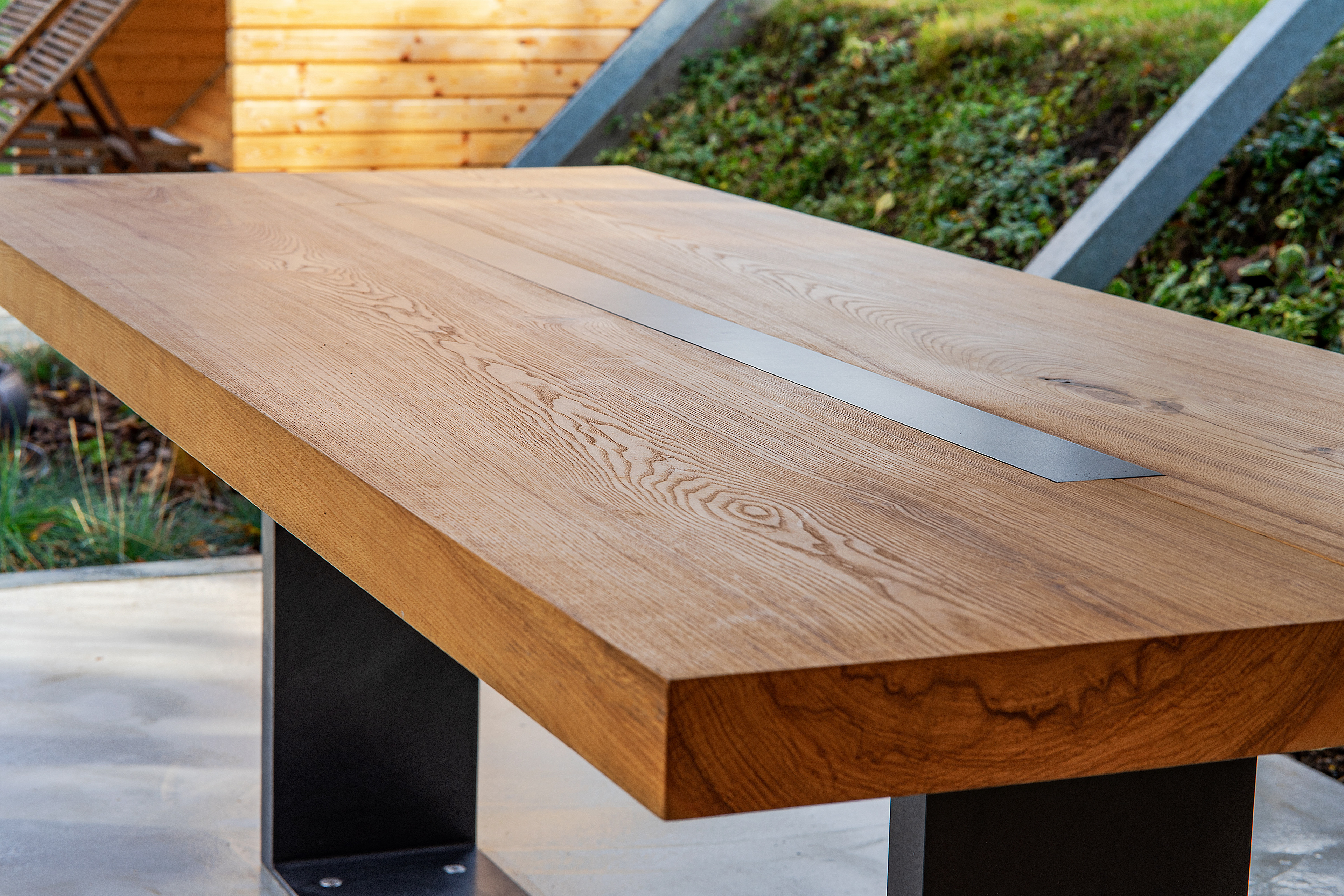 Custom garden table designed for a terrace, with visible wood grain and clean lines