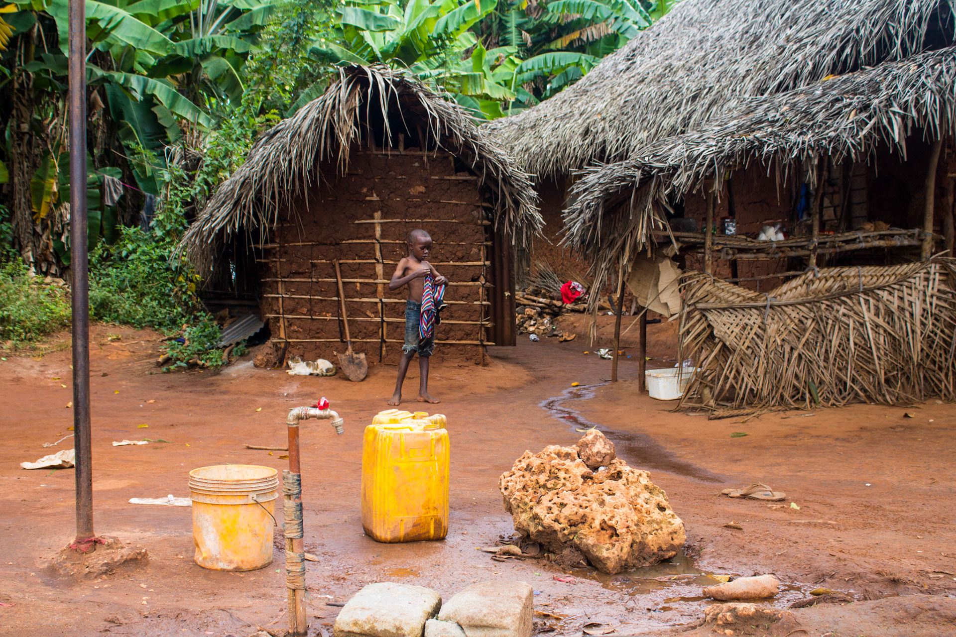 Boy getting dressed for school in a small village on Zanzibar