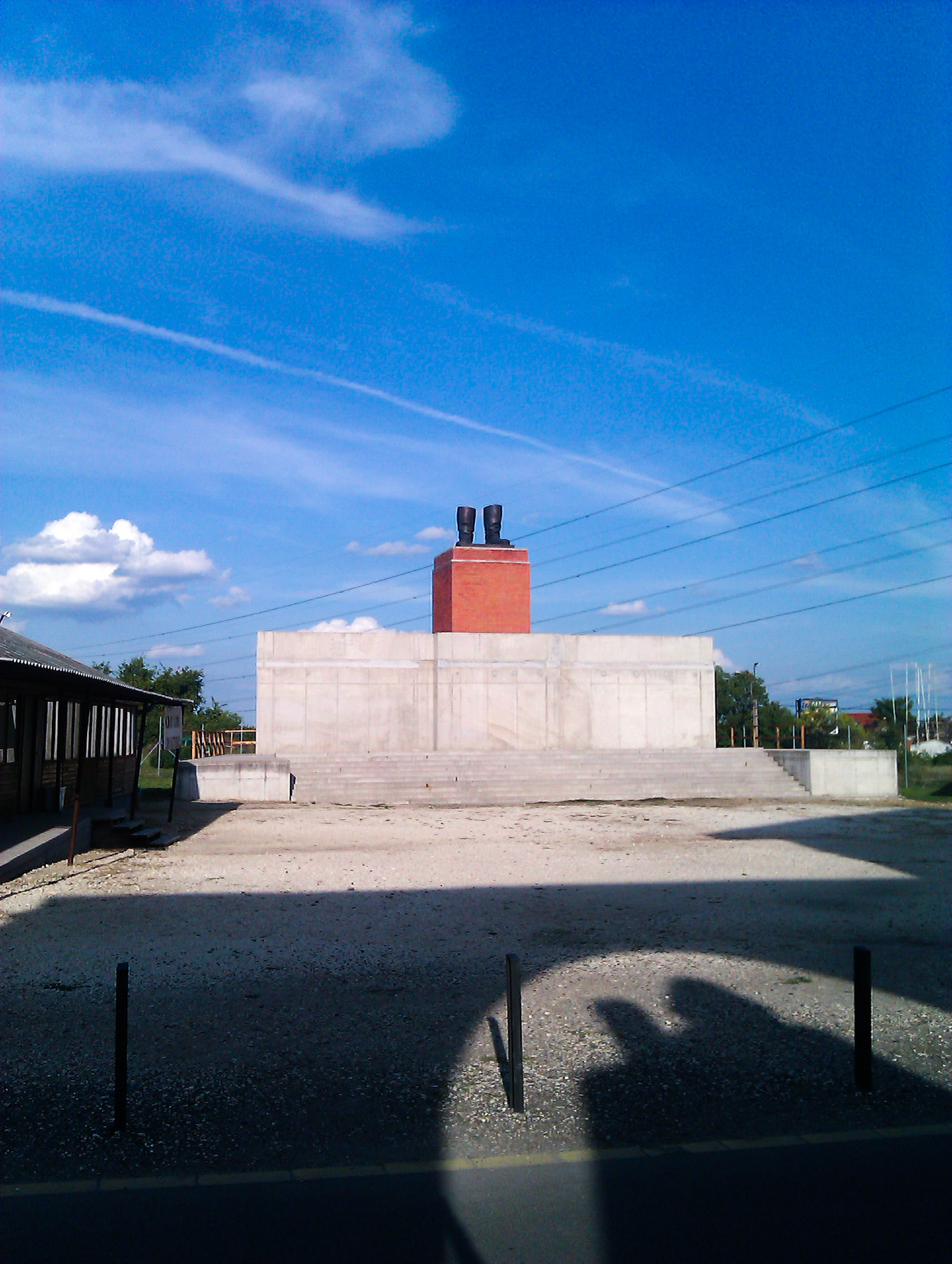Statue of "Stalins boots" (please note the shadows of Marx and Engels), Budapest