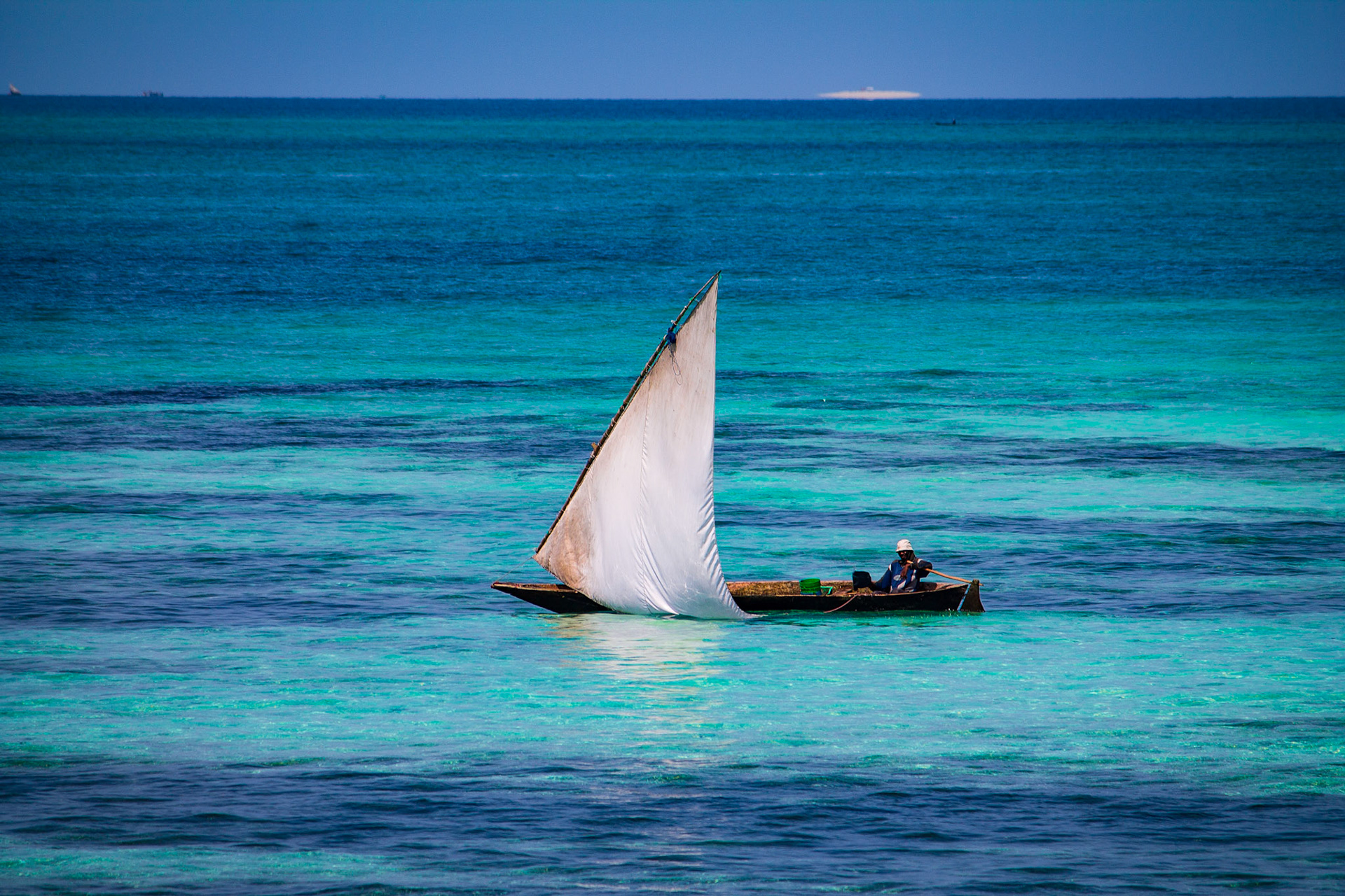 Man sailing a Dhow, Zanzibar