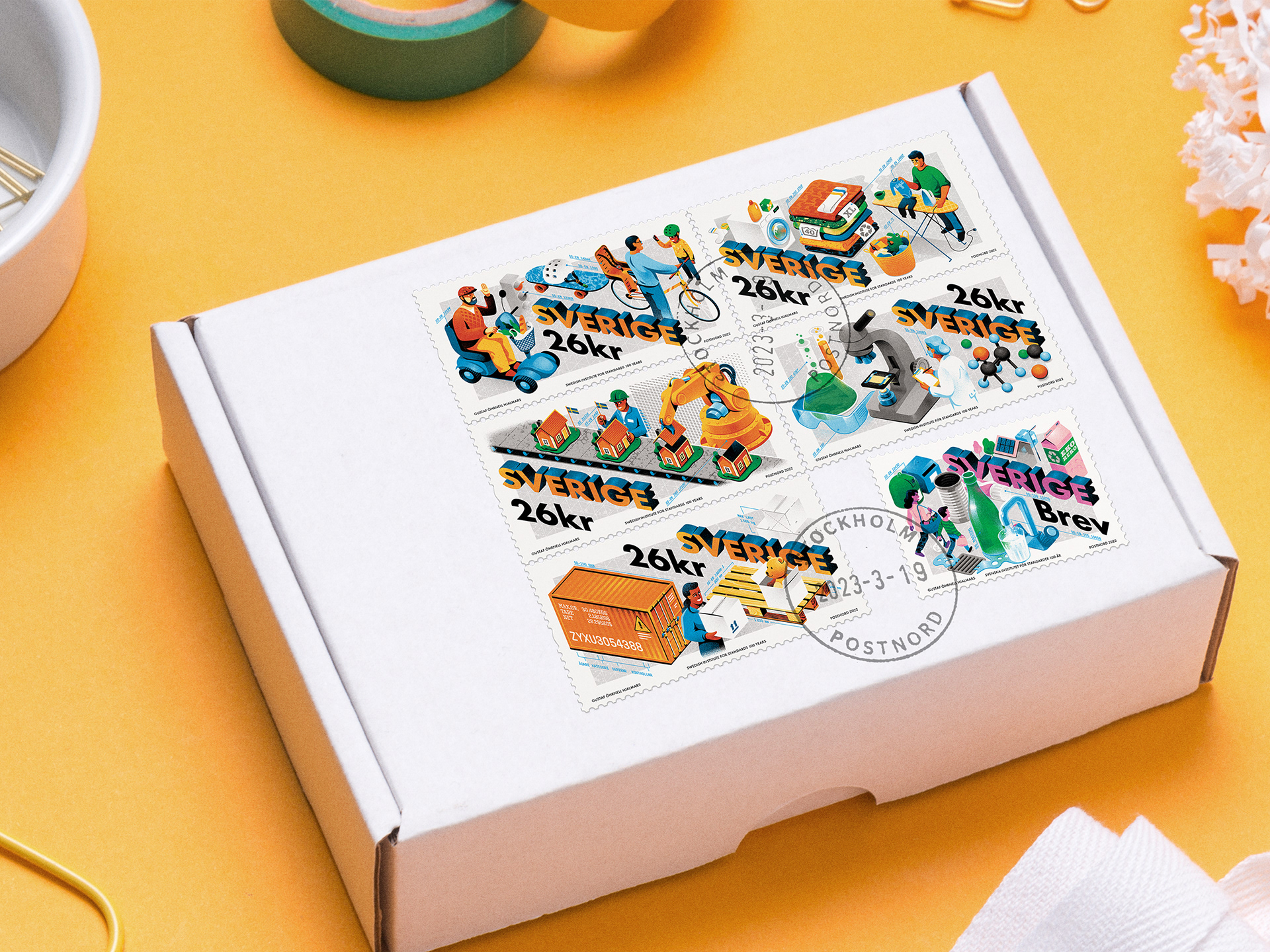 Colorful illustrated stamps, showing everyday objects which are made more accessible through industrial standardization.