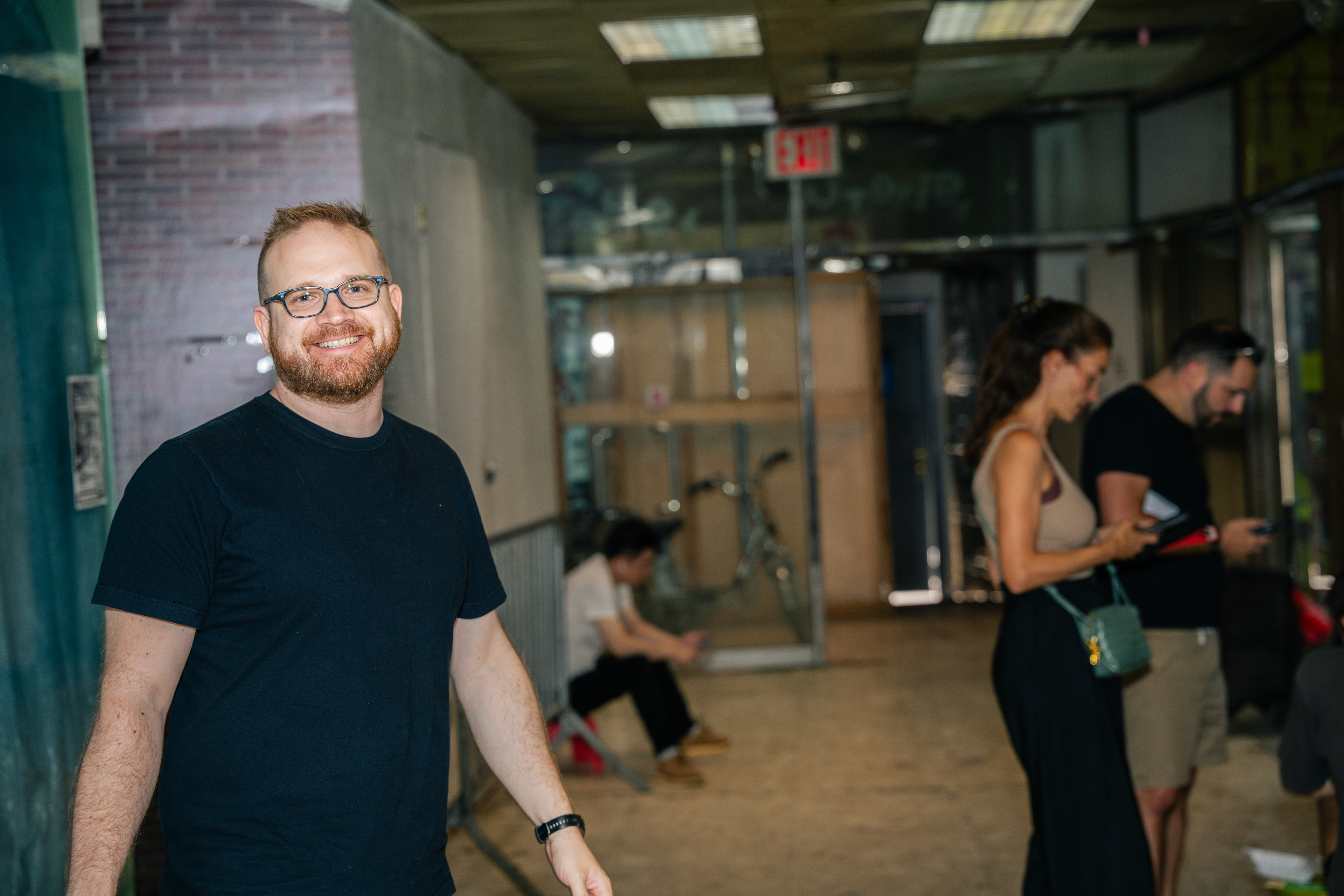 Secretly monitoring event participants, but managed to smile for the photographer. Photo by Jeremy Stanley.