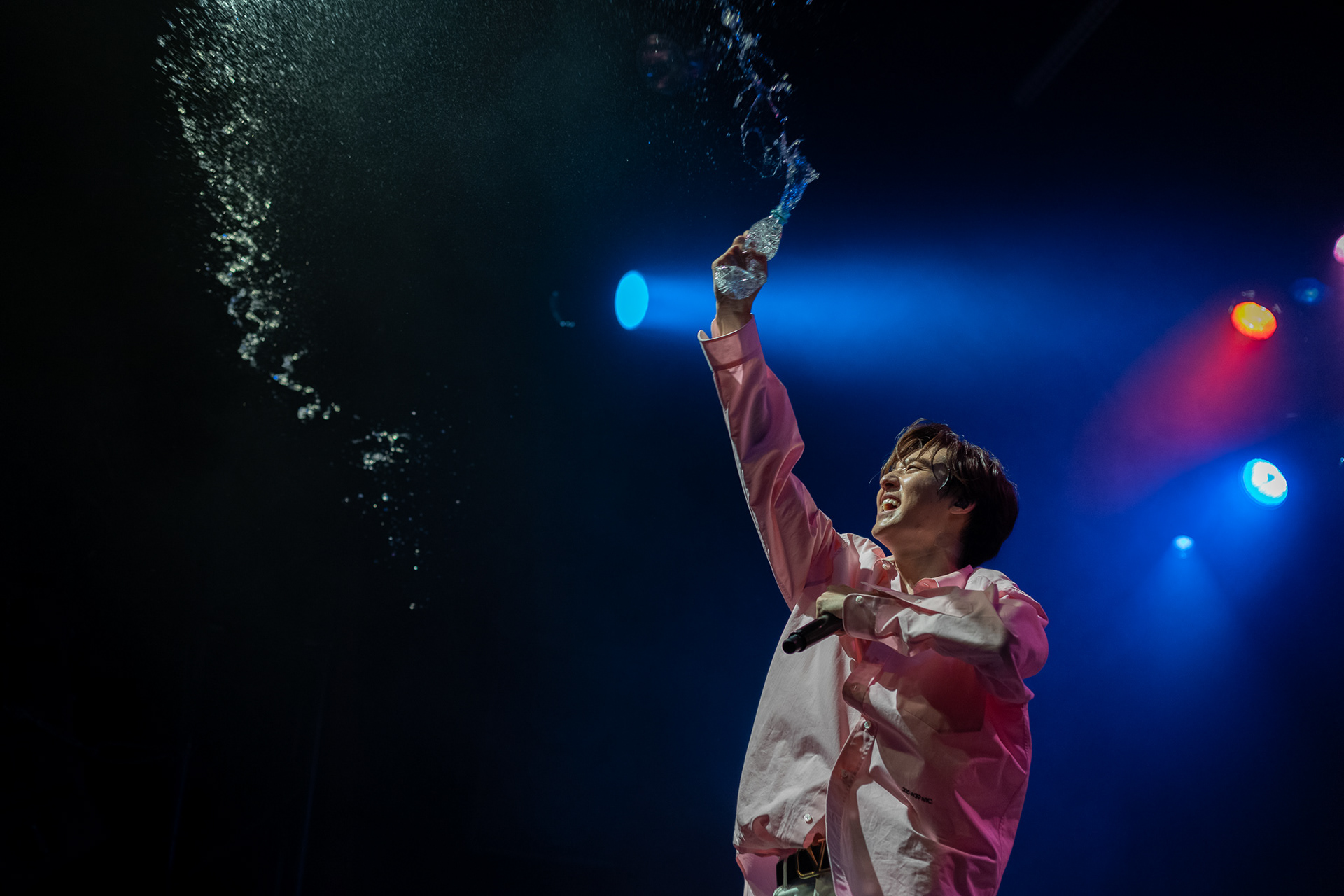 Kevin Woo splashes water on fans at the El Rey Theatre in Los Angeles on Aug. 24, 2019.