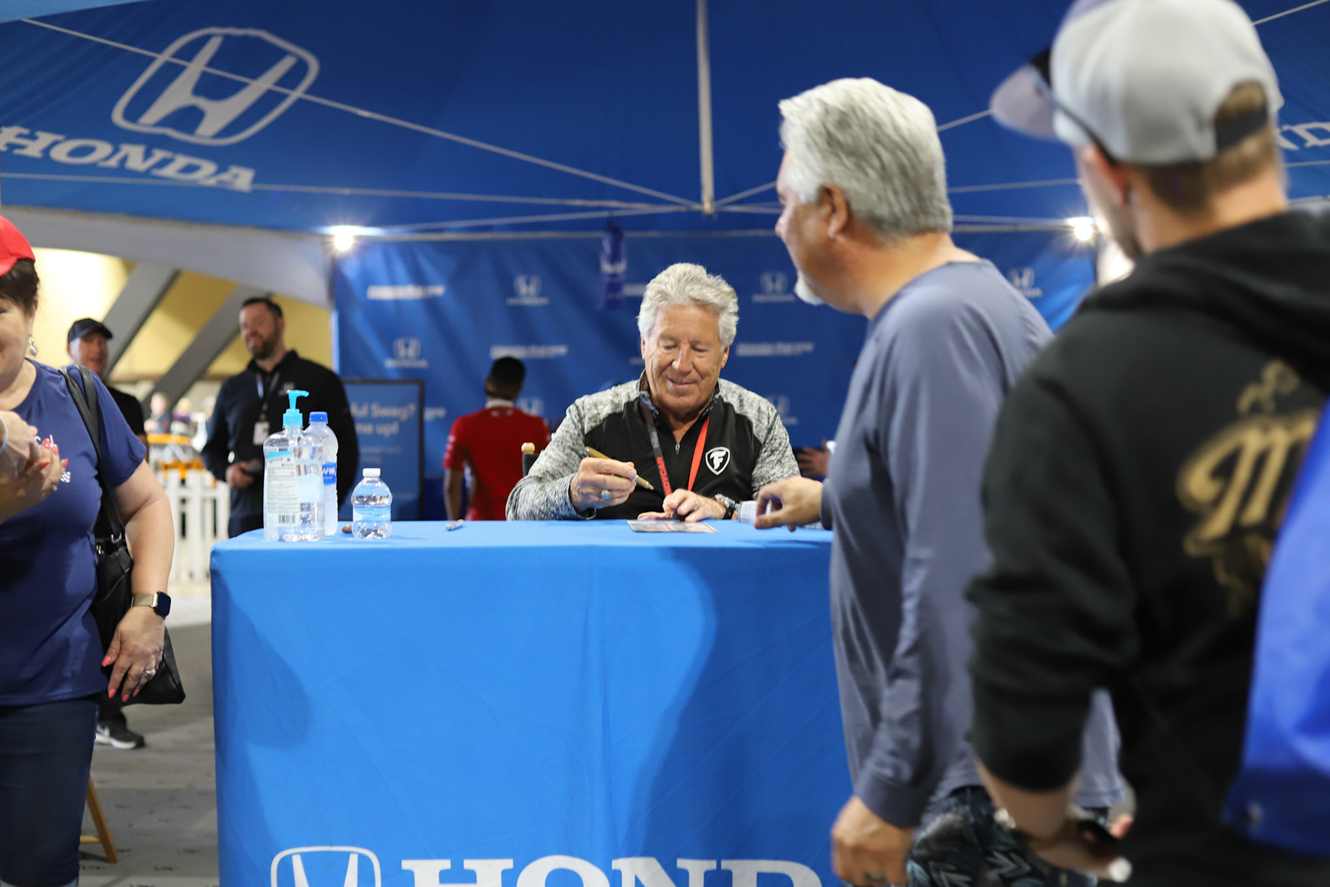 Iconic car racing driver Mario Andretti signs autographs for fans at the 2019 Grand Prix of Long Beach on Apr. 13, 2019.