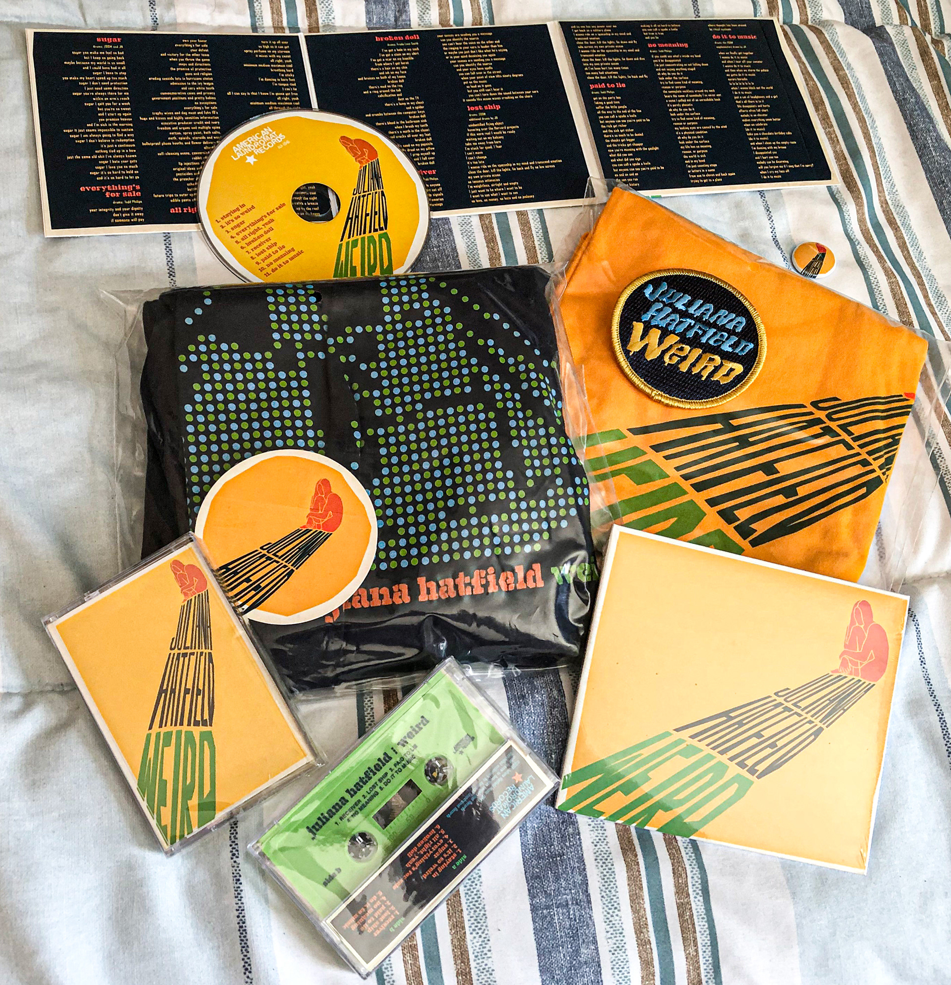 Merch bundle including CD, cassette, embroidered patch, sticker, pin and two t-shirts