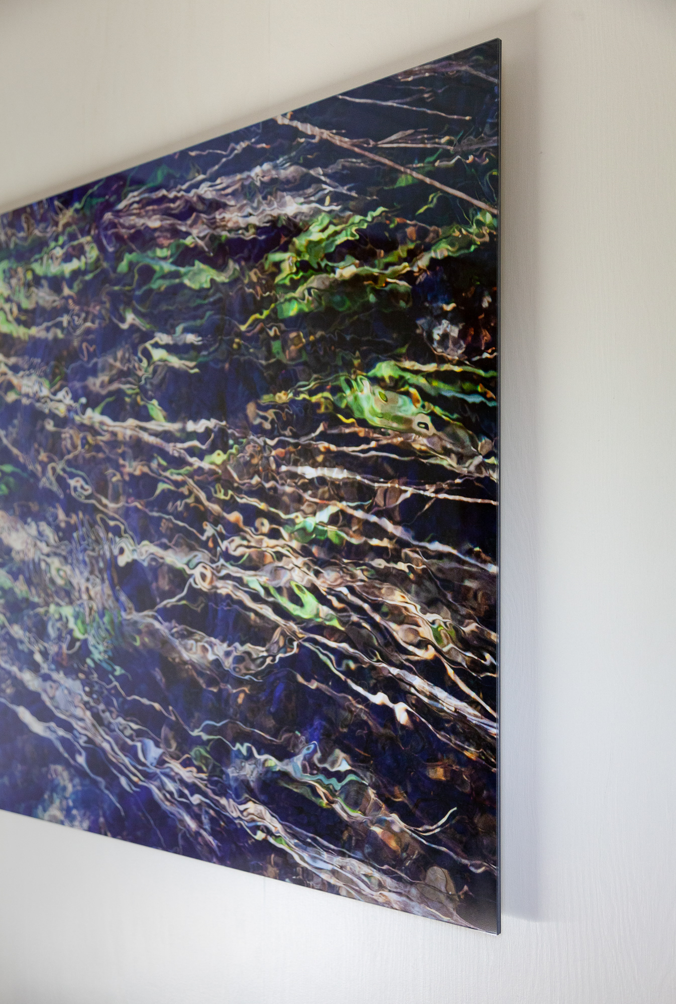 The digital print is made with archival Epson inks and paper. A plexi glass face mount with dibond back mount creates a clean and modern look. An aluminum u-channel on the back adds stability, acts as a spacer to float the piece off the wall and aids in hanging the work. The artist has signed and edition-ed the back of the piece.