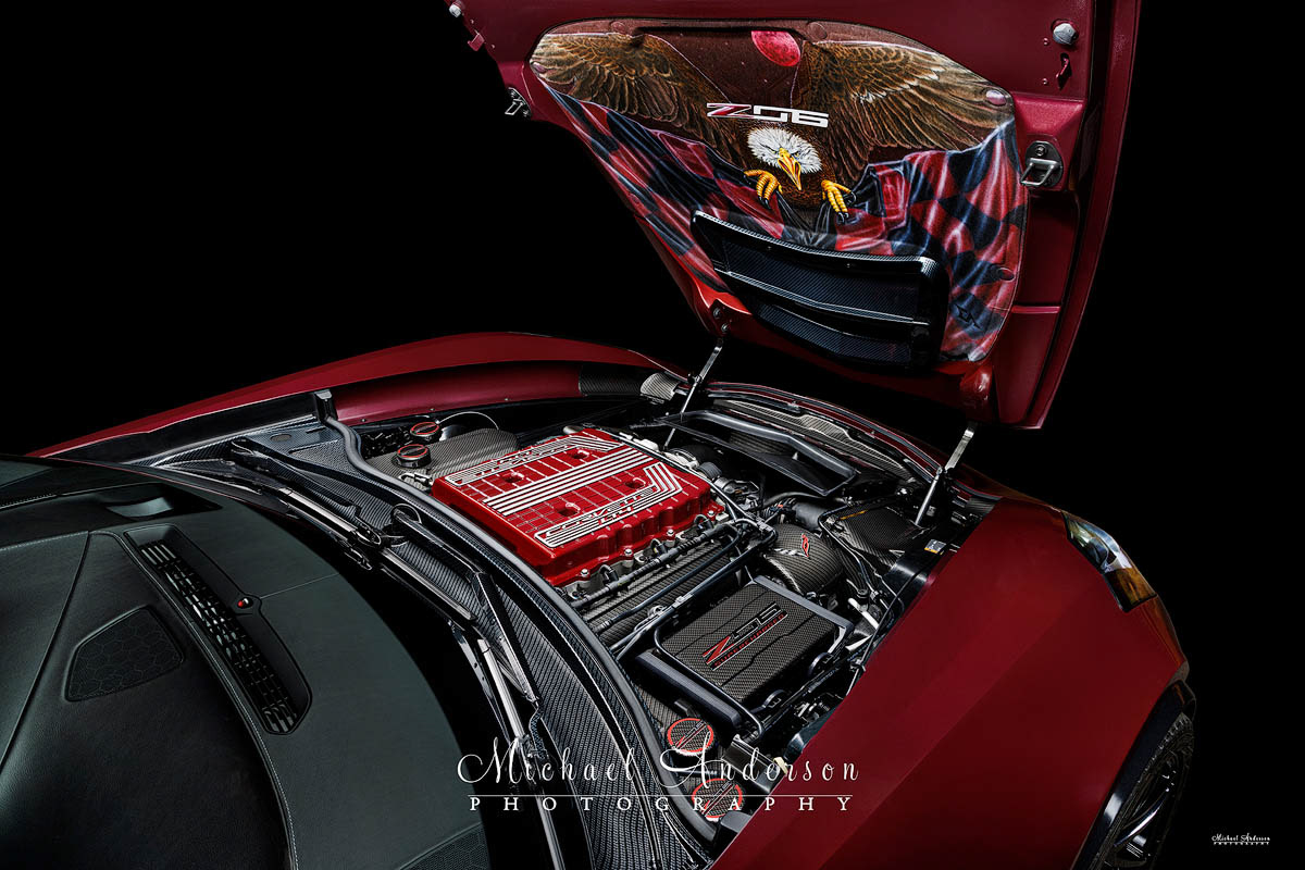 A cool light painted photograph of the engine bay of a 2016 C7 Corvette Z06. I features a hand-painted hood liner featuring a bald eagle and a blood moon!