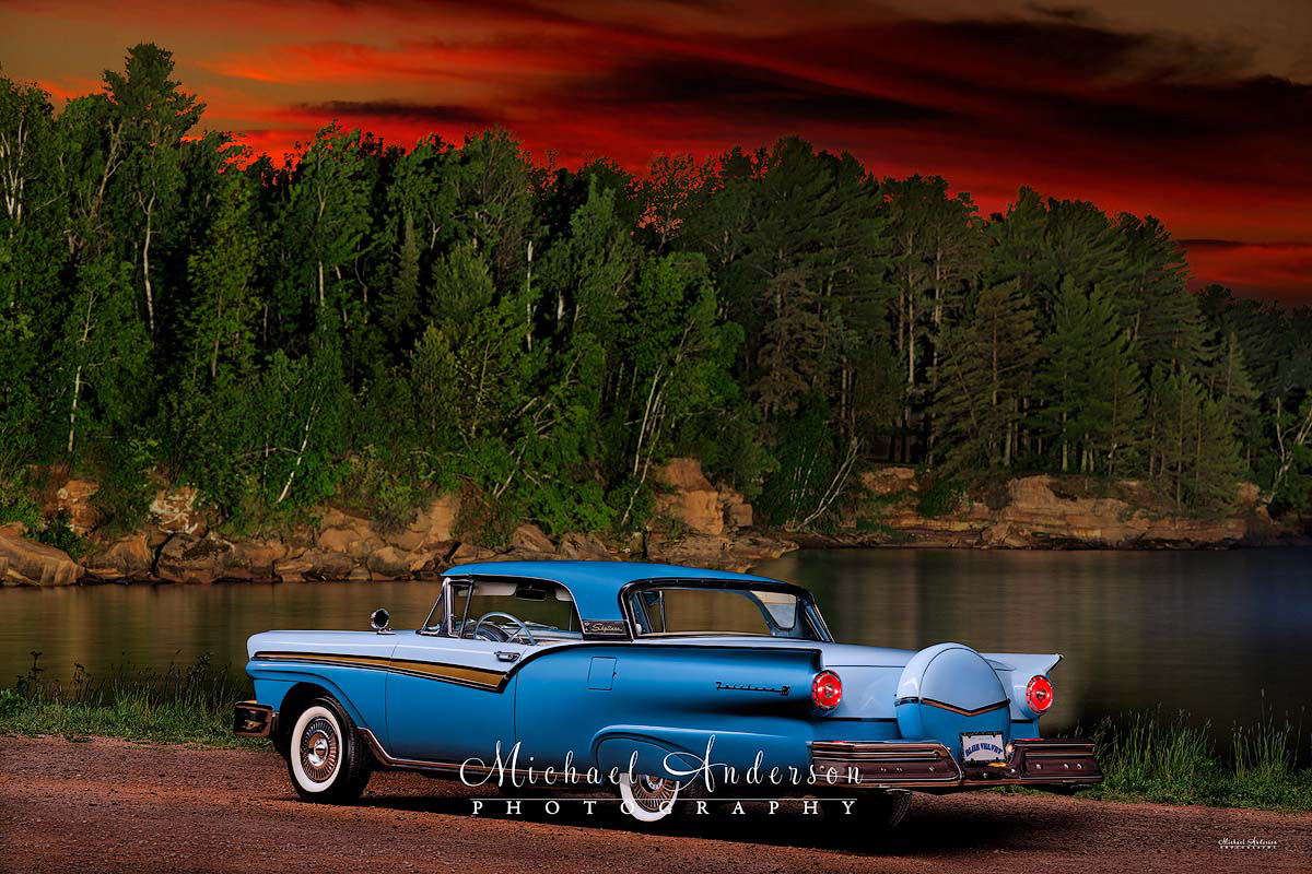 A pretty light painted photograph (rear 2/3rd view) of a 1957 Ford Fairlane 500 Skyliner.