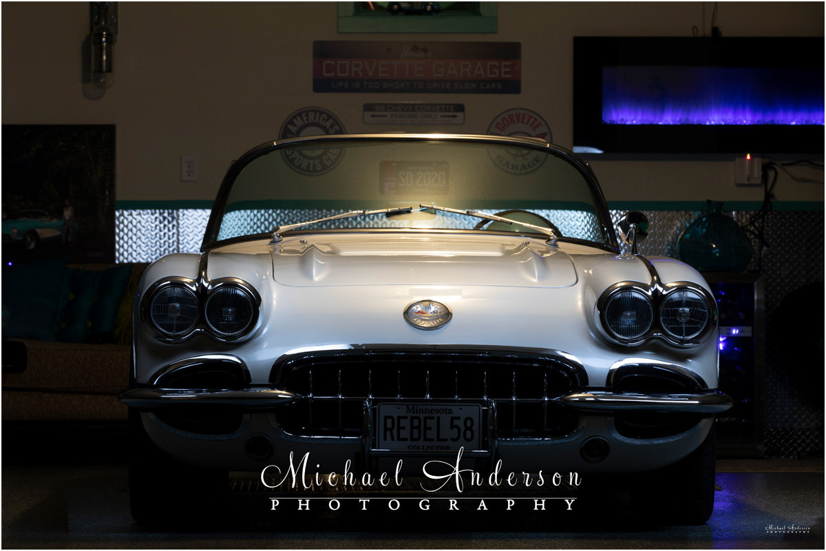 The pre-light painted photo of a '58 C1 Corvette in a garage.