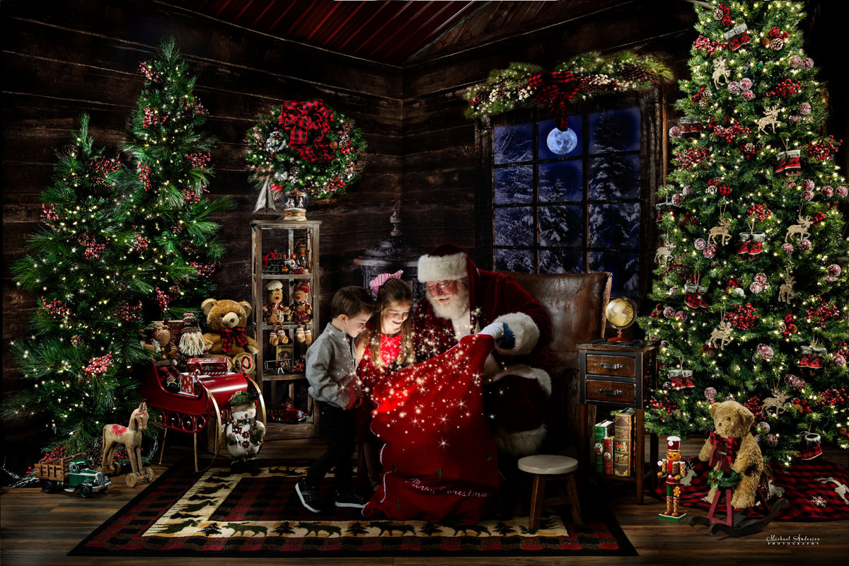 Santa Clause shares a peek into his Magic Toy Bag with a couple of cute kids. The scene is inside of Santa's Cabin, a beautiful rustic place that has been light painted.