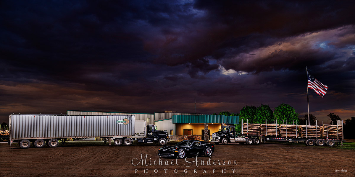A cool light painted photo of a 2023 Kenworth T880, a 2024 Mack P164T, and a 2006 Corvette Z06 in front of Fornengo Forest Products Headquarters in Danbury, WI.