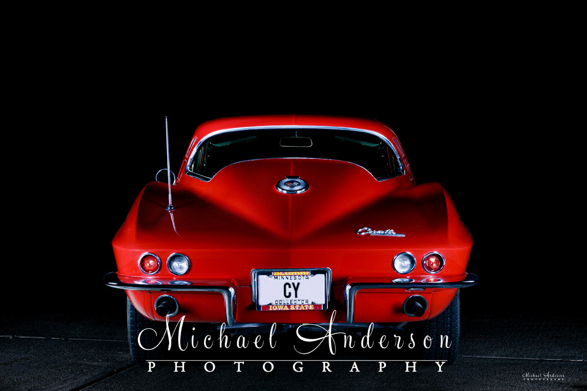 A cool light painted photograph of the rear-end photo of a 1964 Corvette Sting Ray.
