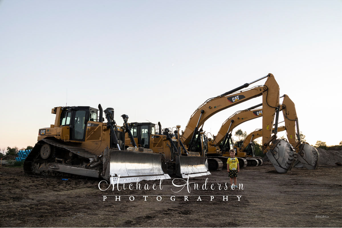 Five construction vehicles, two Caterpillar bulldozers, and three Catapillar excavators, before light painting them.