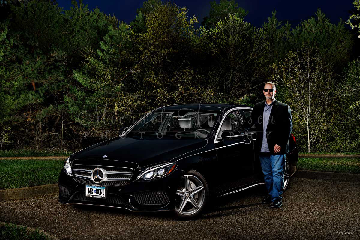 A cool light painted photograph of a black 2016 Mercedes Benz C300, along with the car's owner, at a park in Coon Rapids, Minnesota.