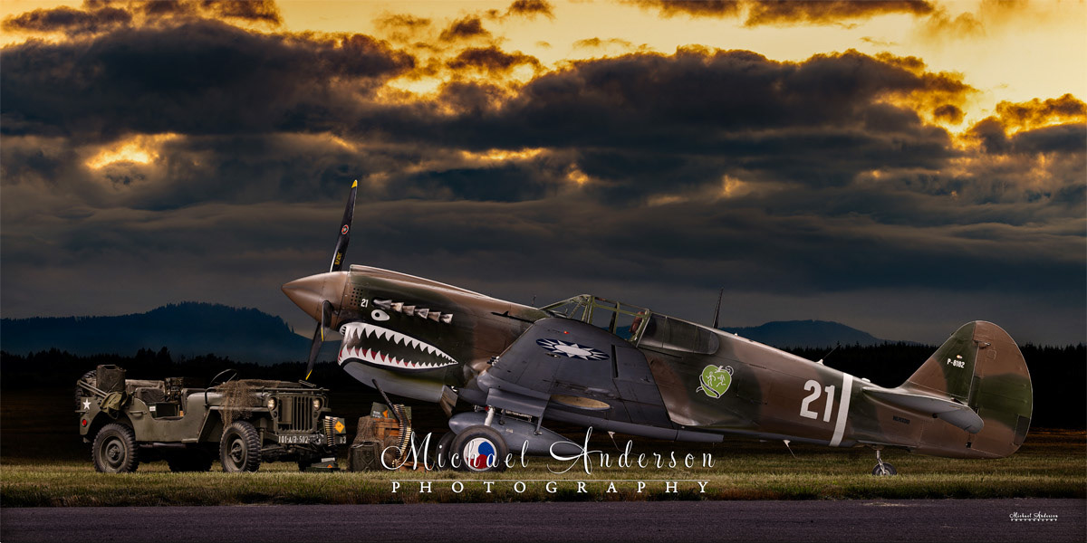 A pretty light painting of a restored1943 P-40 N-1 Kittyhawk with a WWII Willys Jeep.