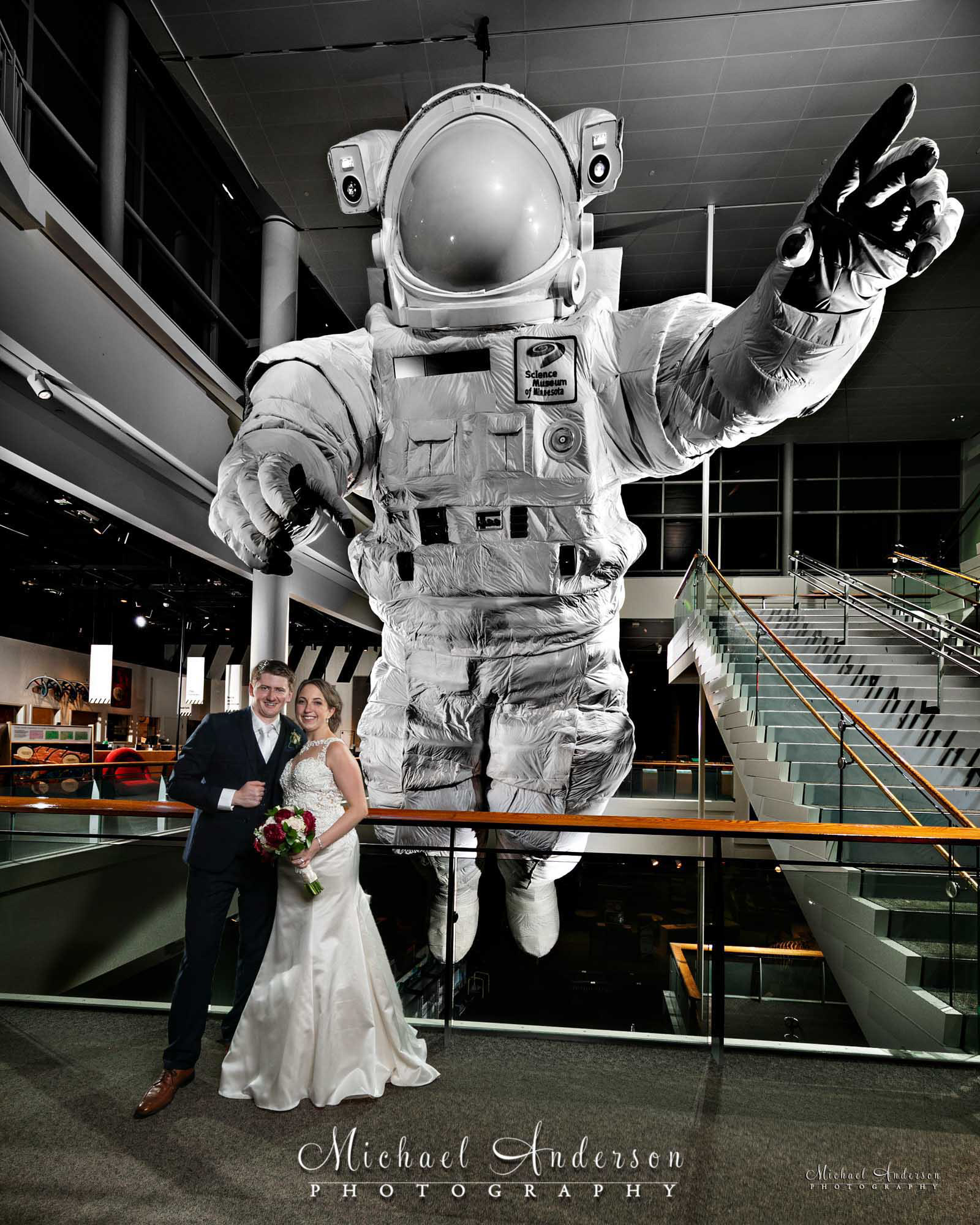 A very unusual light painted wedding photograph created in front of the giant astronaut the Science Museum of Minnesota in downtown St, Paul, MN.