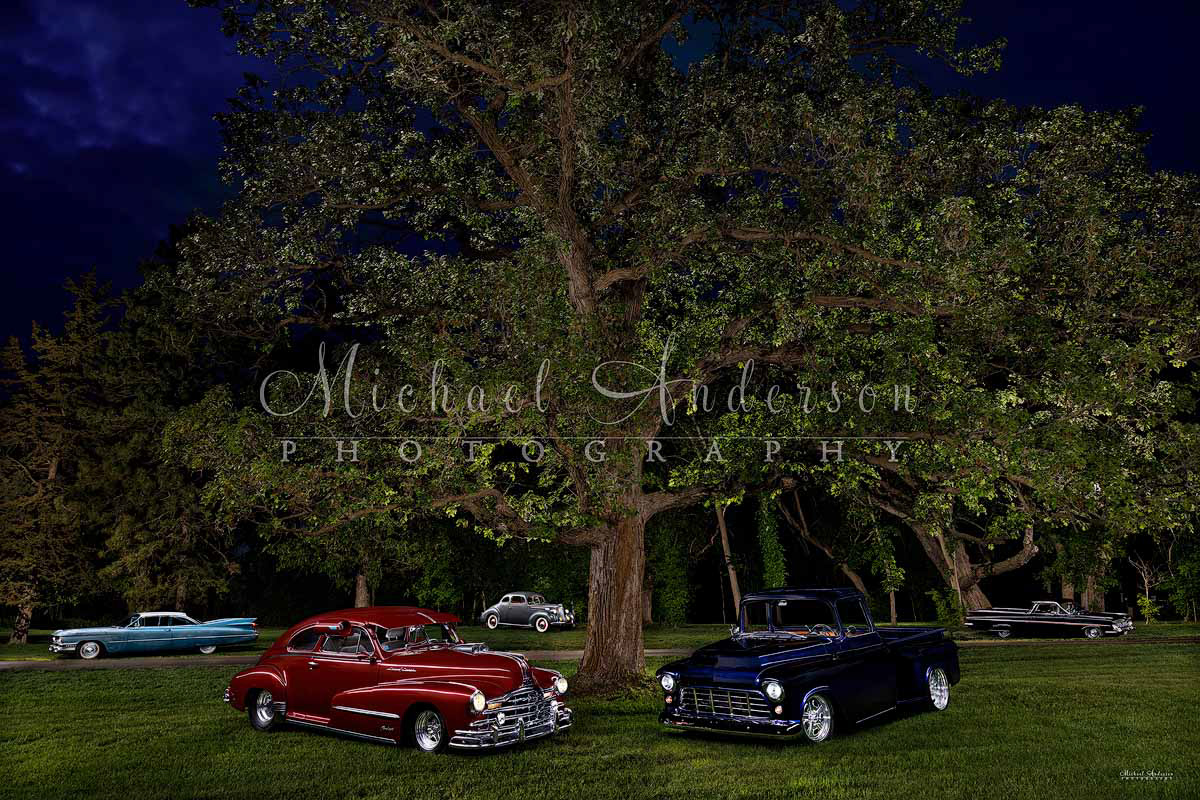 A stunning 5-vehicle light painted photograph created at the client's home! This amazing collection of vehicles includes a 1939 Packard Coupe 110 Series, a mint condition 1948 Pontiac Silver Streak 1955, an amazing Chevrolet 3100 Stepside Shortbox pickup truck, a 1959 Cadillac Coupe Deville, and a 1959 Chevy El Camino.