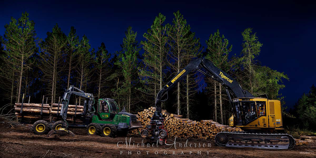 A pretty light painted photograph of a John Deere 1210 Forwarder and a Tigercat H822E Skidder with a Waratah HTH623C Harvester Head.
