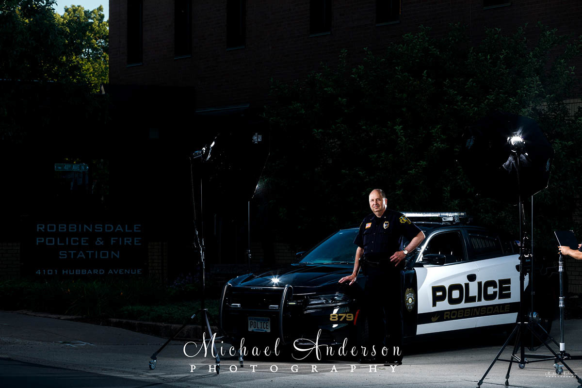 The set-up photo of the Robbinsdale Police Chief in what will become a light painting with a squad car.