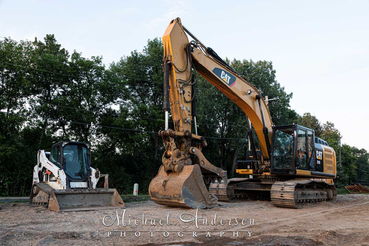 Photo of a CATERPILLAR 329 E L and a Bobcat T590 prior to light painting them at a construction site.
