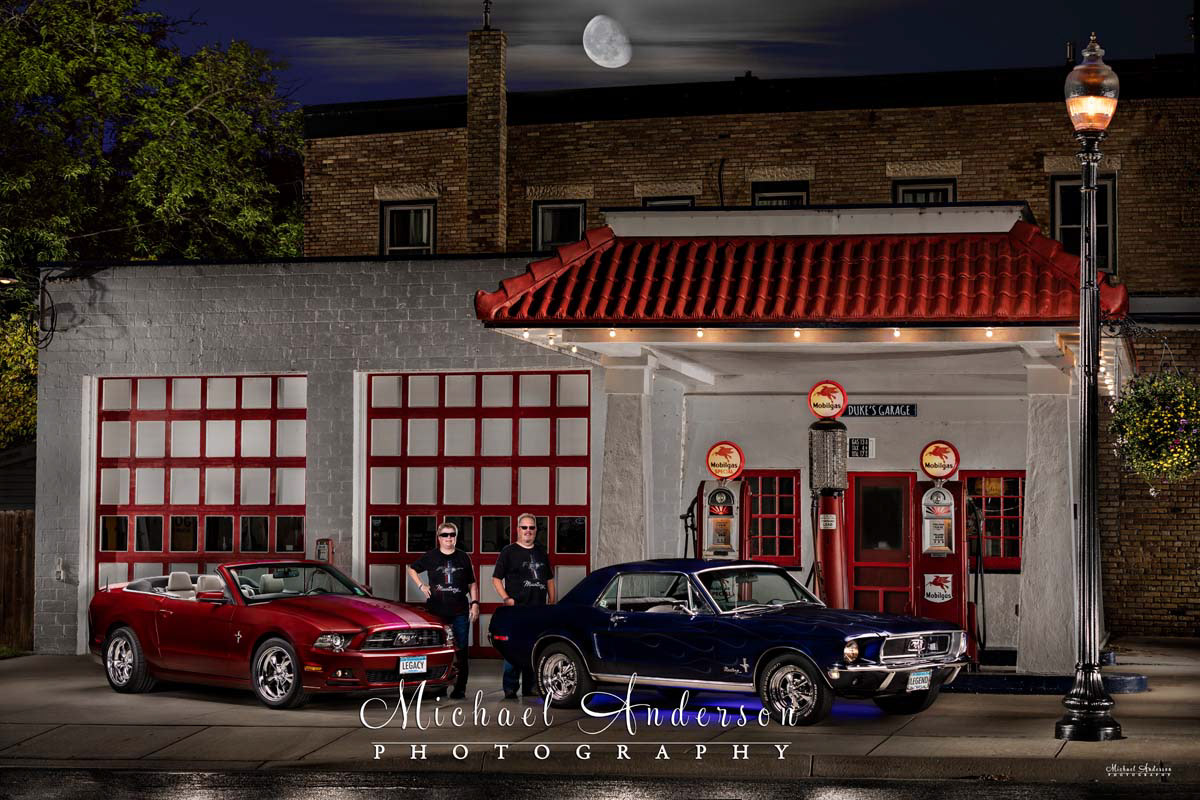 A beautiful light painting of a pair of Ford Mustangs, a 1968 and a 2014, and the owners of the cars. Image was taken at Gregg's Vintage Restored Gas Station in Carver, MN.