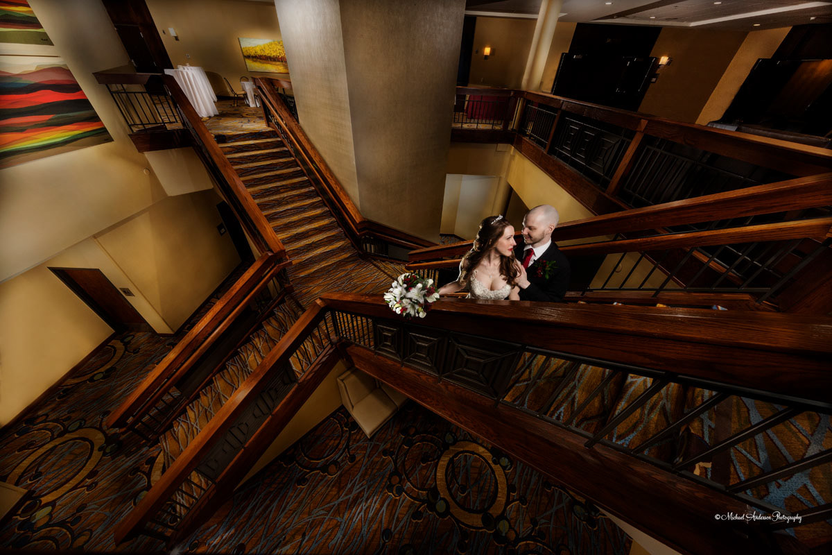 A crazy wide-angle light painted wedding photo of the bride and groom on a wooden staircase at the Minneapolis Marriott Northwest in Brooklyn Park, MN.
