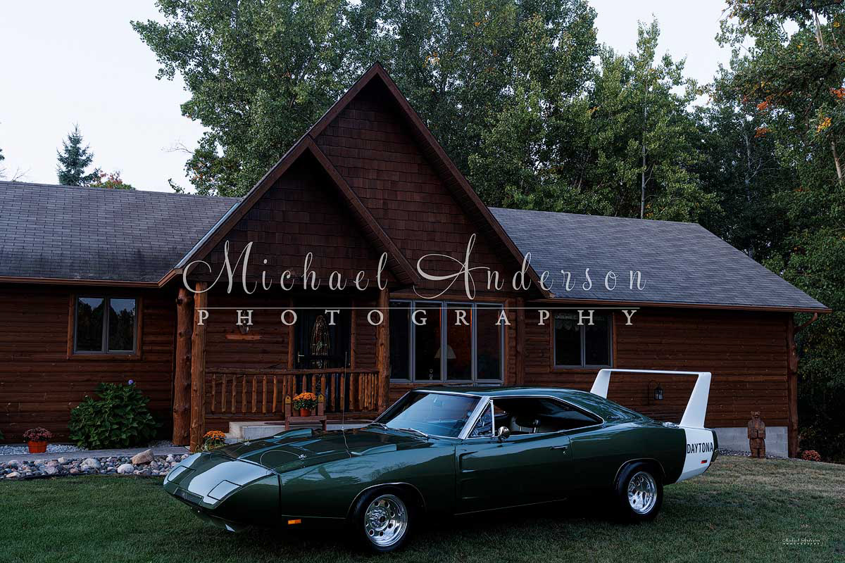 The set up photo, before light painting it, of a one-of-a-kind 1969 Dodge Daytona at a log home.