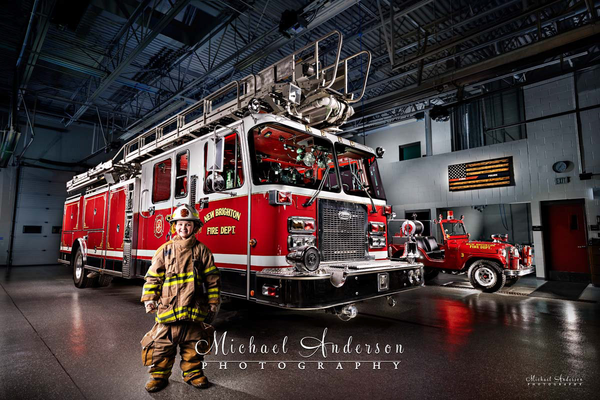 Light painted photo of New Brighton Aerial #498, 1955-CJ-5-Jeep #3, and a junior firefighter.