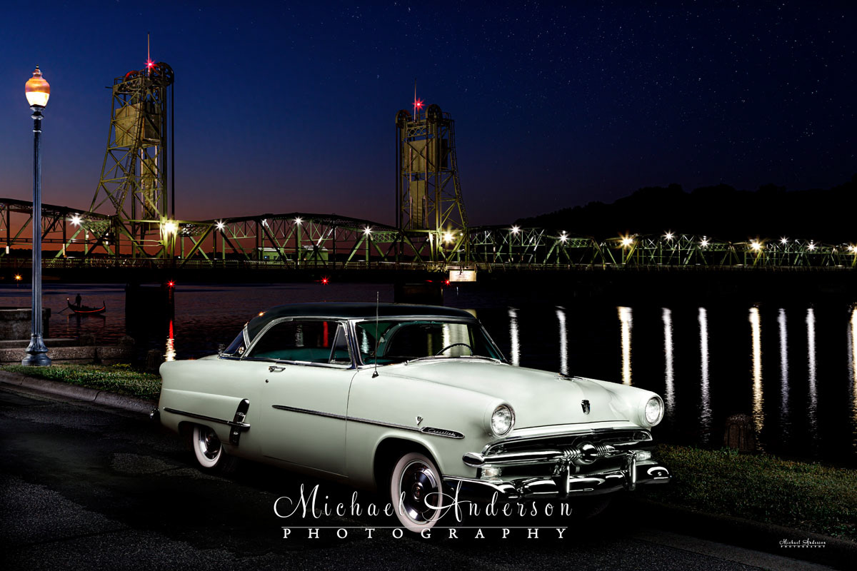 A pretty light painting of a Ford Crestline Victoria by the famous Stillwater Lift Bridge in Stillwater, MN.