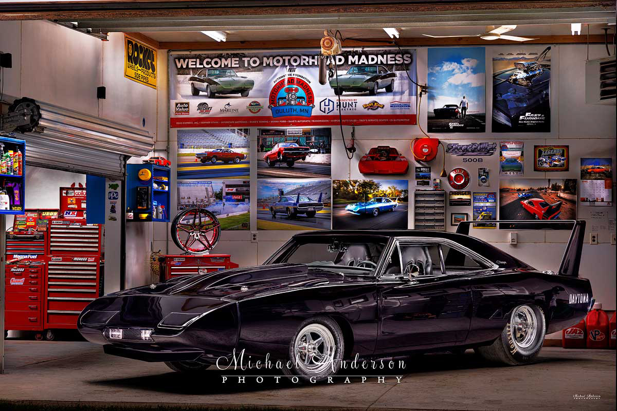 A cool light painted photograph of a 1970 Dodge Charger 500 that's been converted into a 1969 Dodge Charger Daytona tribute car.