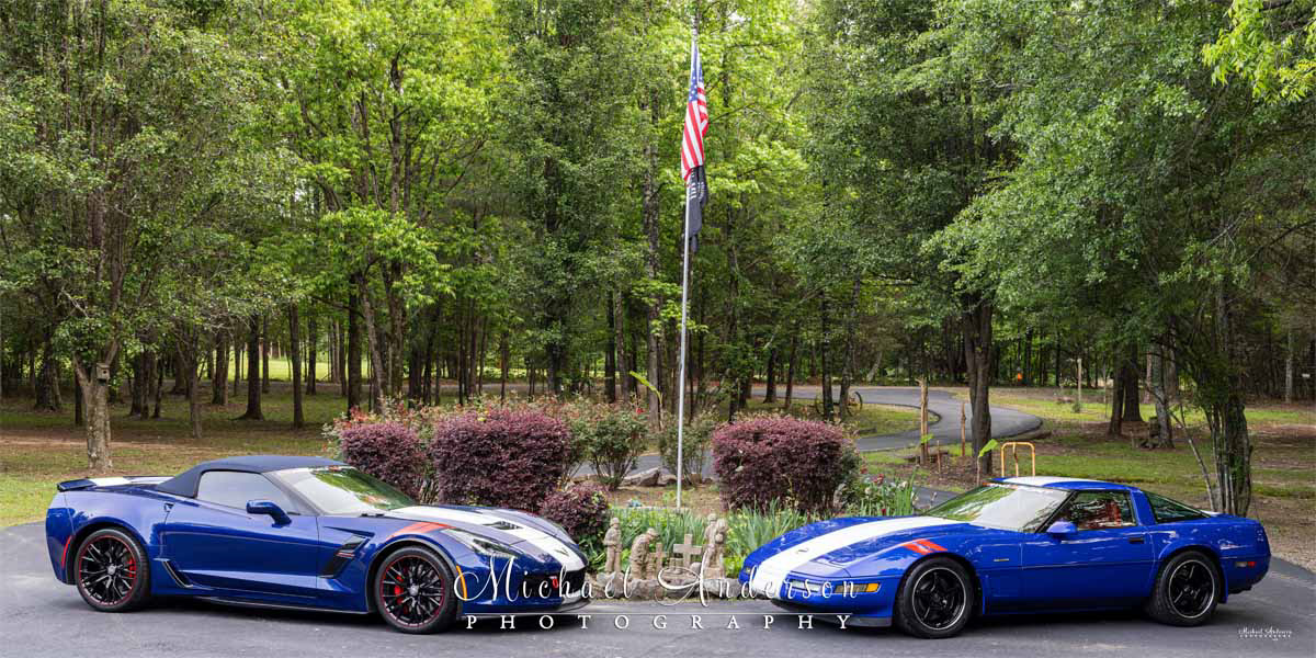 Behind-the-scenes photo of a pair of Red, White, and Admiral Blue Corvettes prior to light painting them and the scene. 
