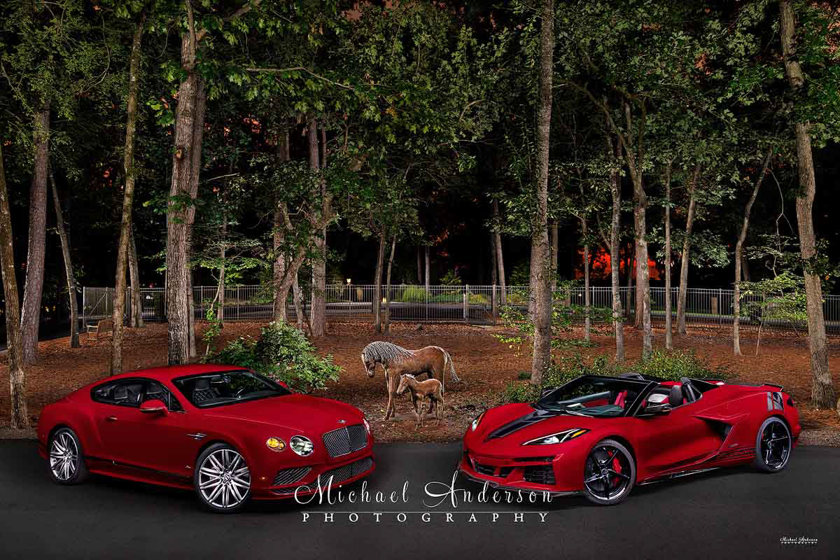 A pretty light painted image of a 2016 Bentley Continental GT Speed along with a 2025 C8 Corvette E-Ray. A cool sculpture of two horses is in the background of the image.