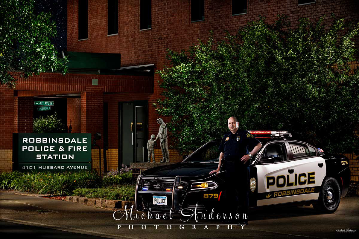A cool light painted photograph of the Robbinsdale, MN Police Chief and a Dodge Charger Police Interceptor.