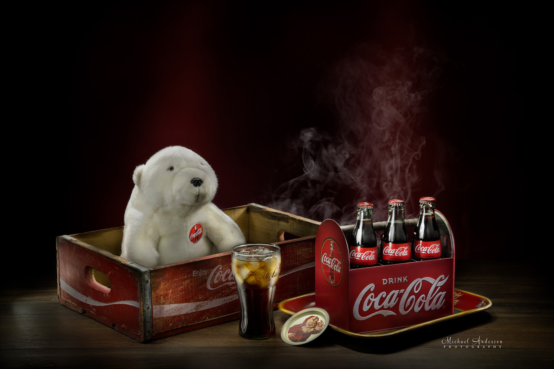 A light painted photograph of some vintage Coca-Cola products and a studio setting.