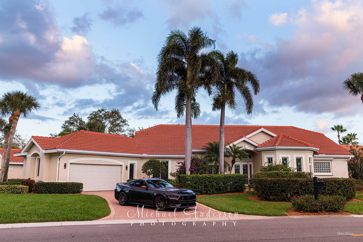 The setup photo of a 2024 Ford Mustang GT and the client's home prior to light painting them.