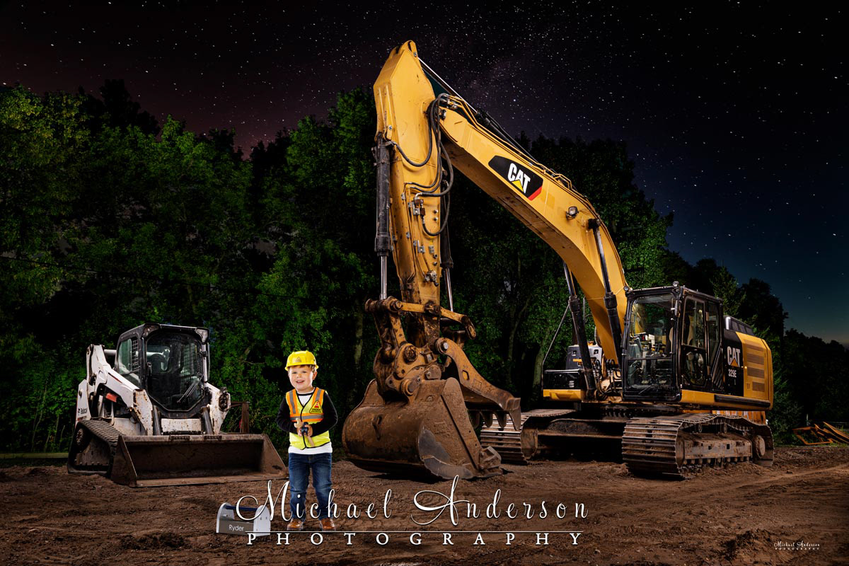 A really cool light painted photograph of a CATERPILLAR 329 E L and a Bobcat T590 under the starry sky at a construction site in New Brighton, Minnesota. A little boy was added in post-production (for obvious safety reasons).