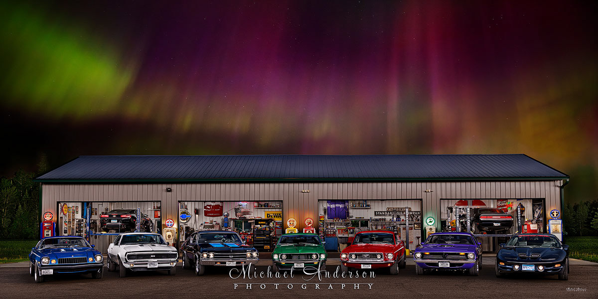 A stunning light painted photograph of nine muscle cars under the Aurora Borealis in northern Minnesota.