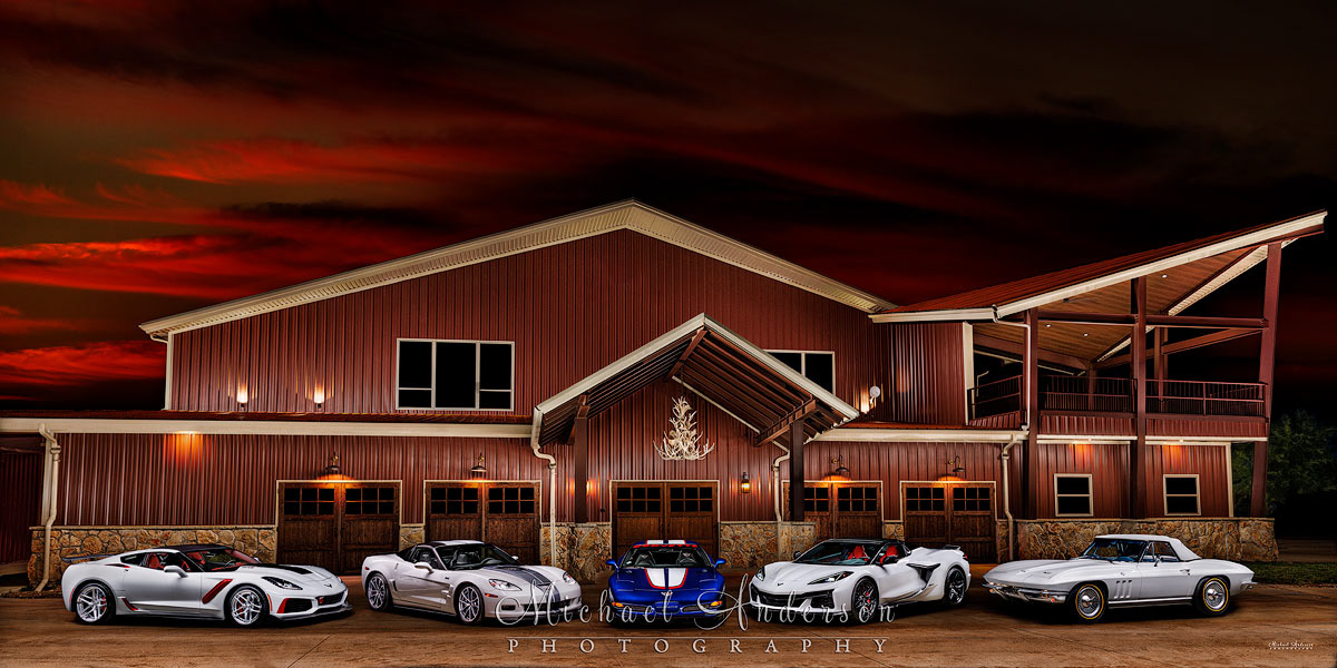 A beautiful light painted photograph of five Corvettes created in front of a hunting lodge. The five Corvettes are: a1966 Corvette Stingray Convertible, a 2004 Corvette C6 Z06 Leman’s Commemorative Edition, a 2013 Corvette 60th Anniversary ZR1, a 2019 Corvette ZR1, and a 2023 Corvette Z06.
