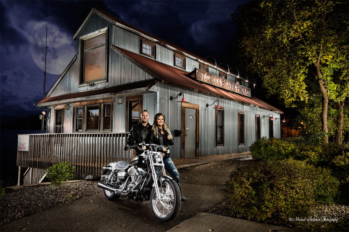 A pretty light painted engagement portrait of a cute couple with their Harley Davidson Motorcycle. This unique engagement photo was created at St. Croix Boat and Packet in Stillwater, Minnesota.