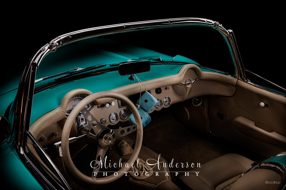 A nice light painted photo of the interior of a 1957 Corvette.