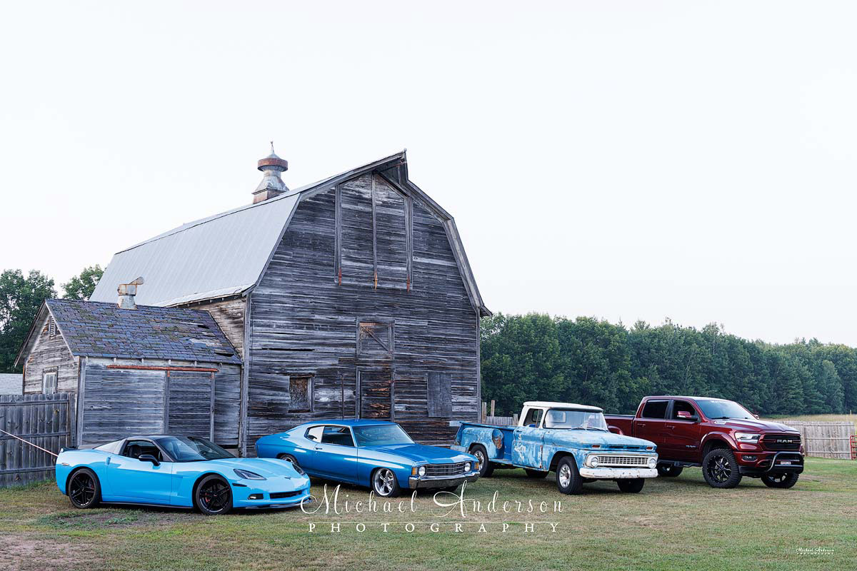 Photo of a 2009 Corvette, a 1972 Chevelle, a 1963 Chevy Stepside C20, and a 2021 Dodge Ram truck prior to light painting them.