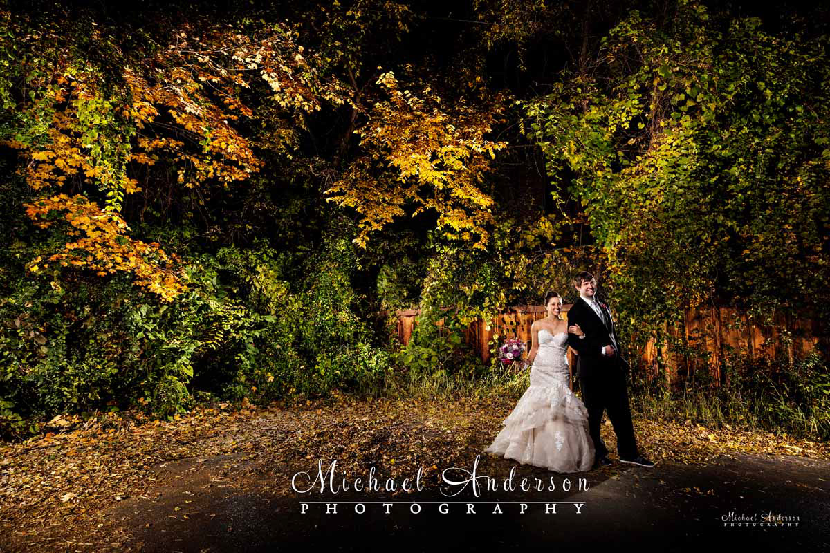A pretty light painted wedding photo of the bride and groom in stunning fall colors in Stillwater, MN!