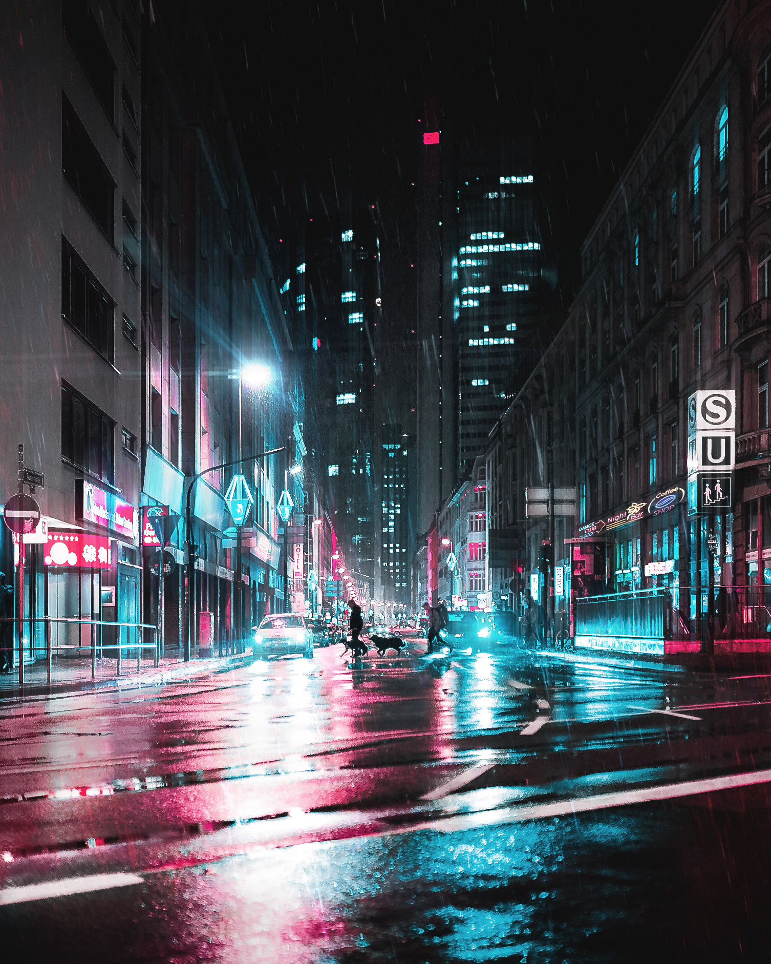 frankfurt at night. Rain on the streets. streetphotography at night of people crossing the road. Vibrant colours