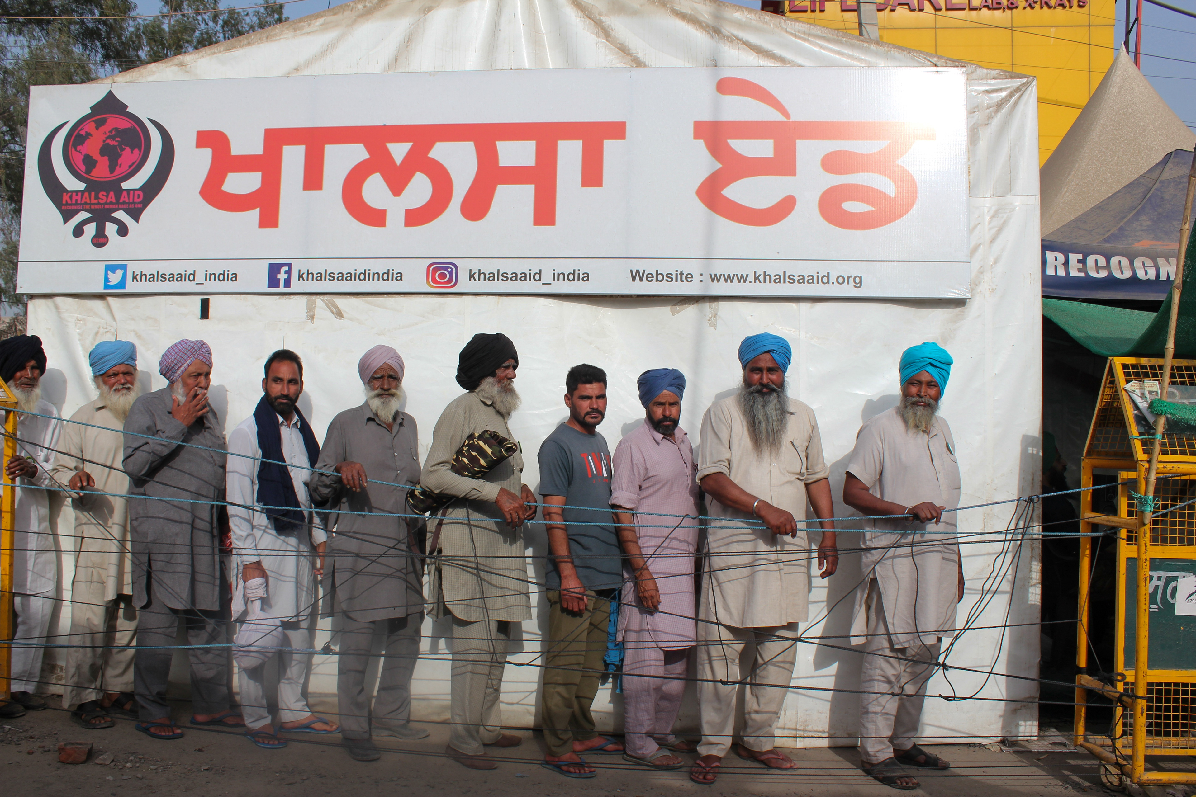Protesters wait in line to get ration from the Khalsa Aid camp at Singhu Border.