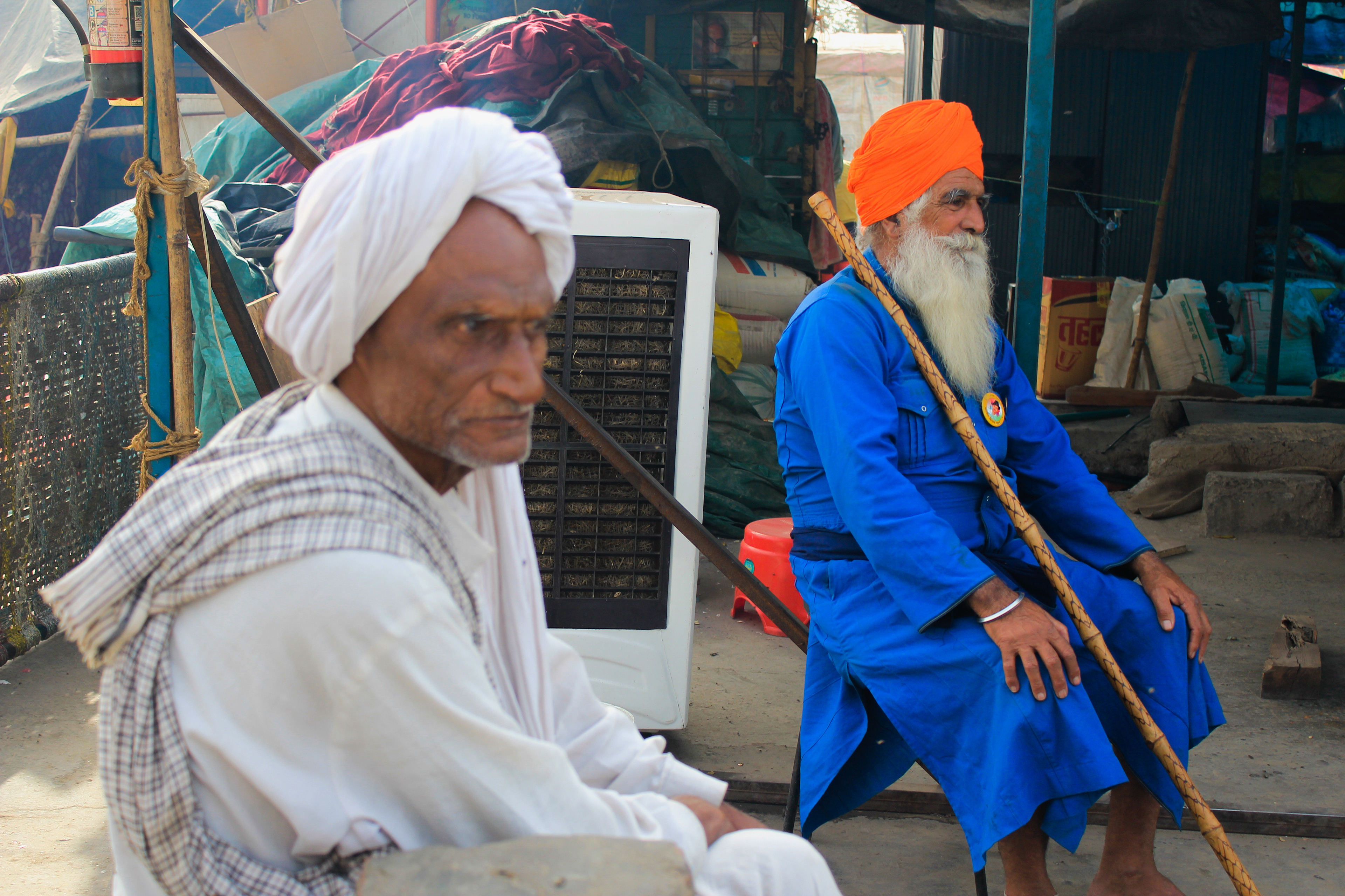 Two men chant slogans of freedom from the government and demand the farm laws be repealed.