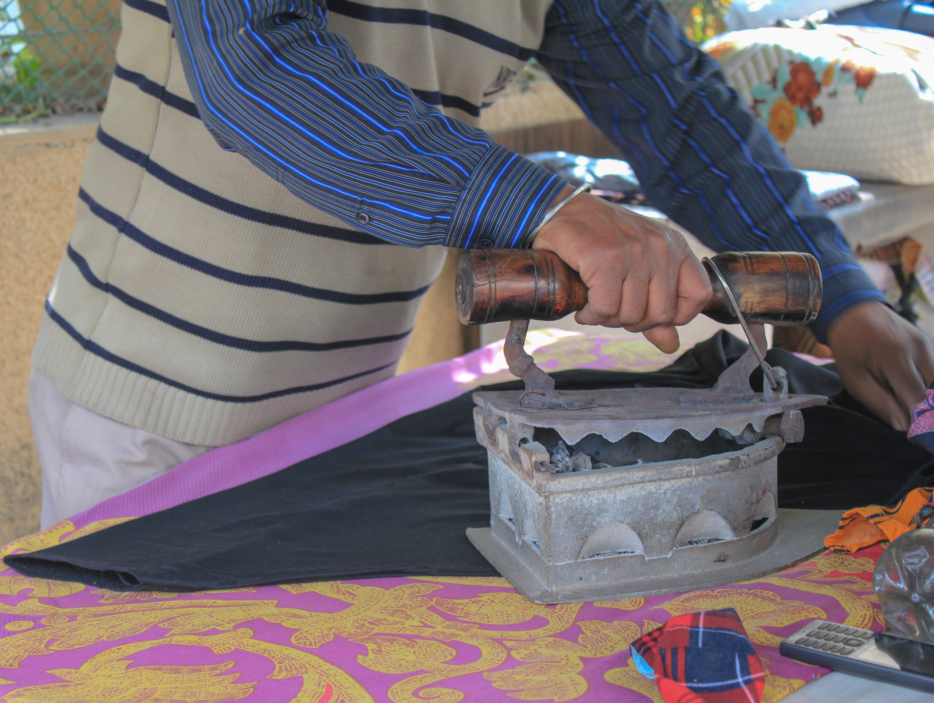 Chandar, 45, is ironing clothes for the residents of the Madhuban neighborhood since 1995. After his father passed away, he took on this job to follow his father's footsteps.