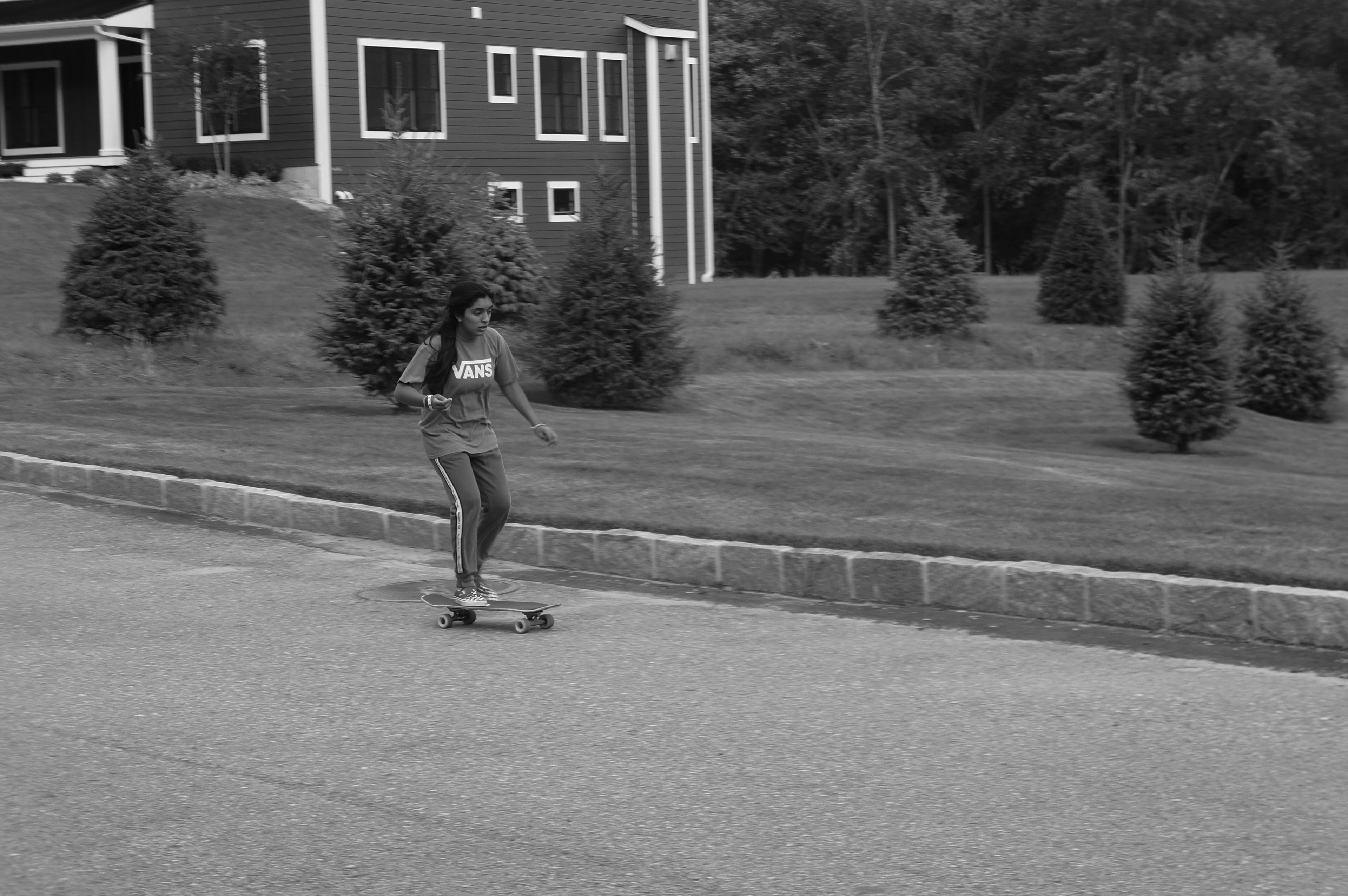 Briarcliff, NY, 18 Sept. Panning shot of Ashna gliding through the wind on her skateboard,