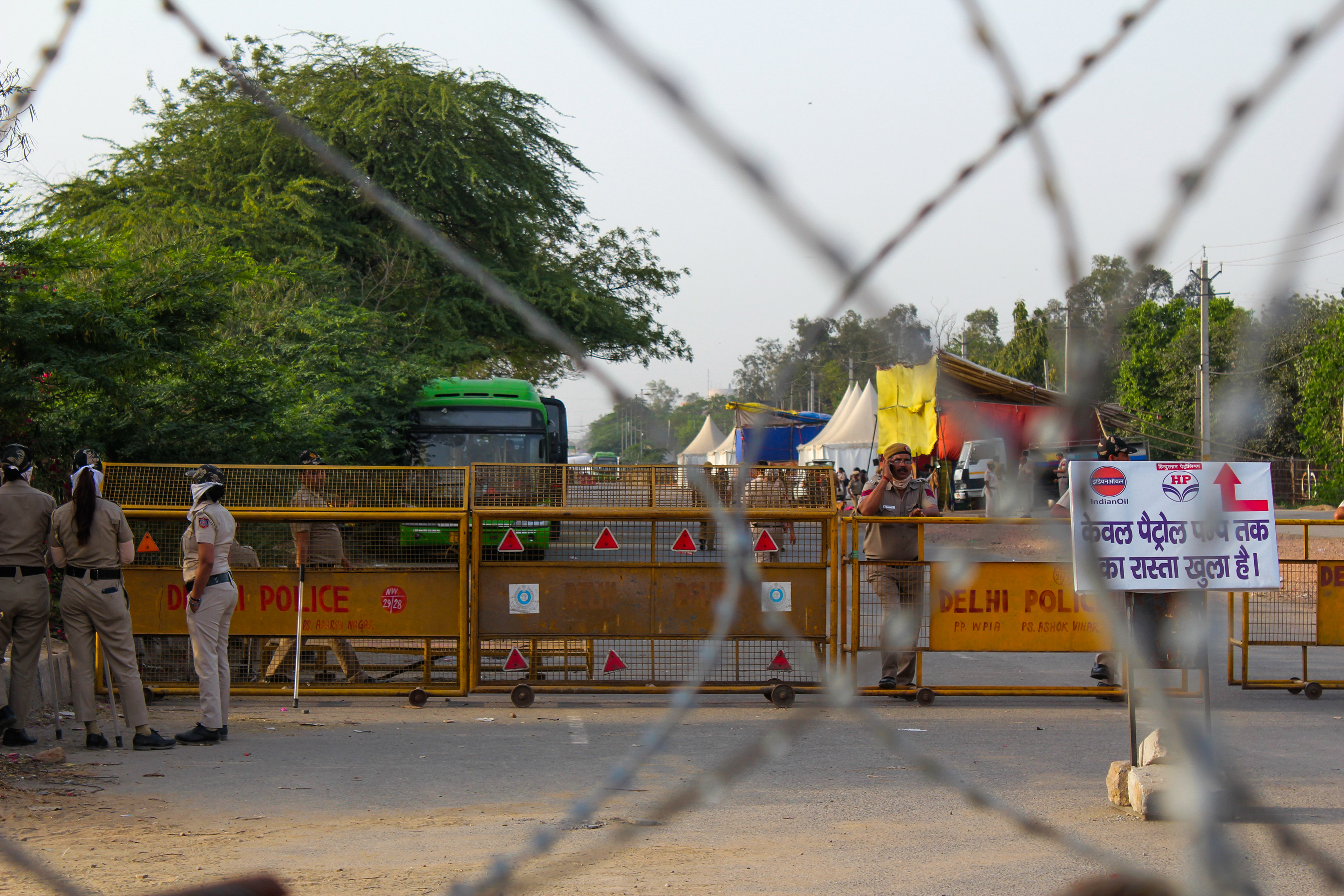 As one reaches the Farmers Protest at the Singhu border, they are welcomed by barricades and wires preventing passersby from entering the protest site. There are many security forces such as the police and military personnel at the border.