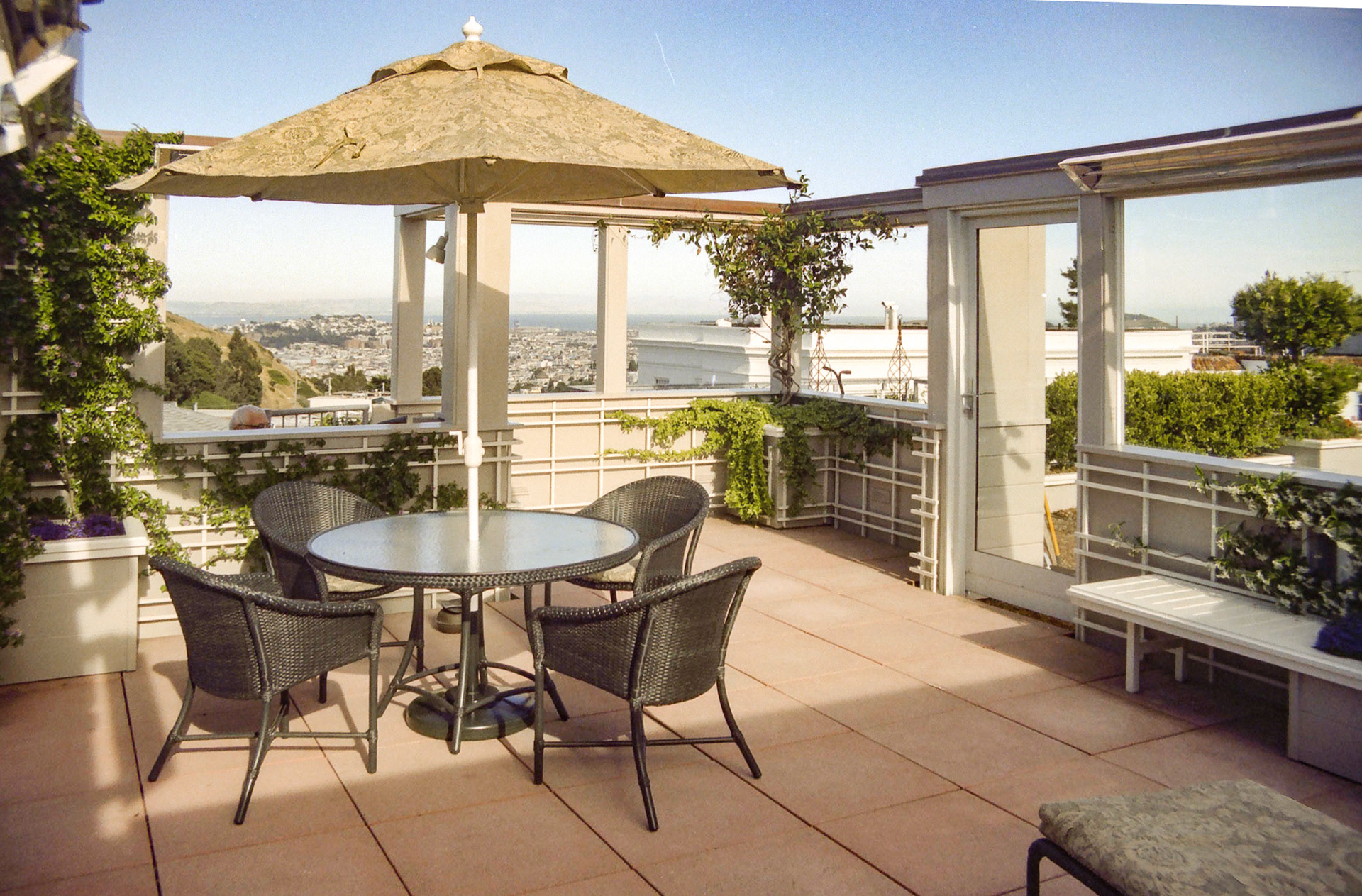 The roof deck is enclosed with an open top to the sky. Access is by an external spiral stair.