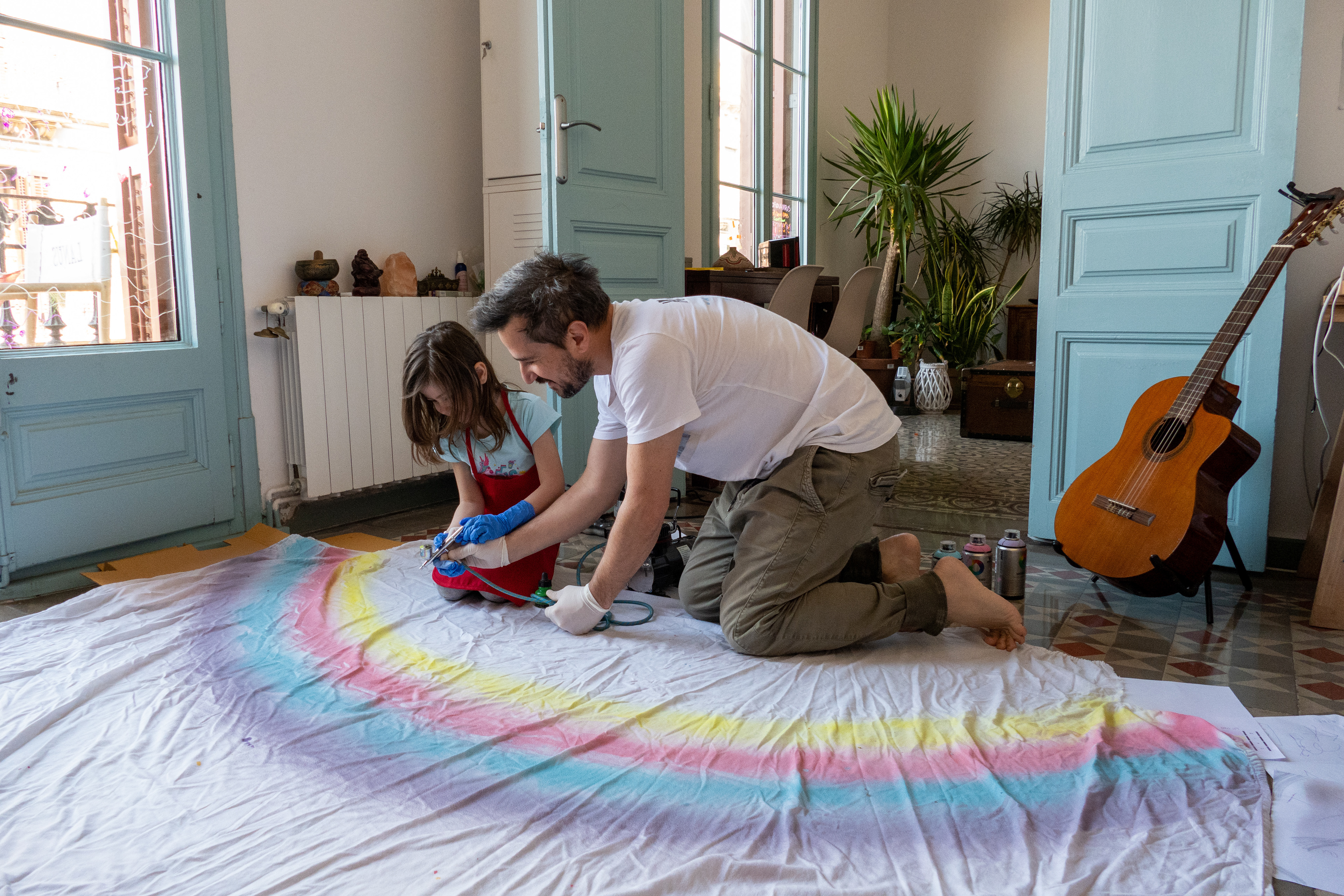 Sophie and I making the famous rainbow flag with the message "Everything will be OK" to cheer people up while being locked down in our appartement in Barcelona